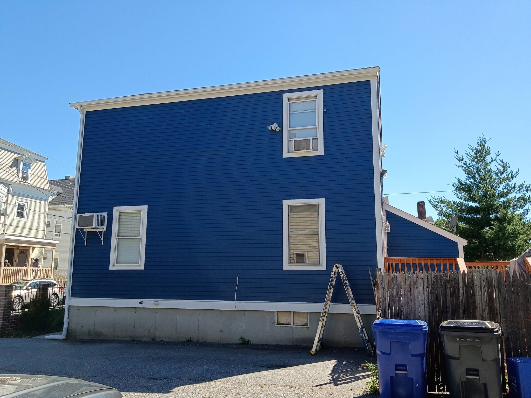 Side elevation of freshly painted blue siding